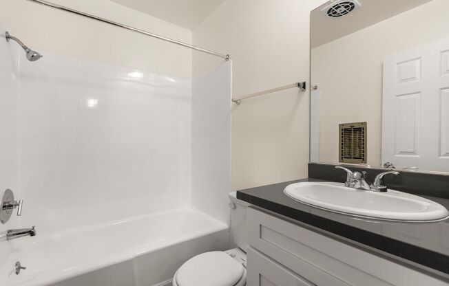 a bathroom with a sink toilet and bathtub