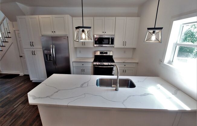 GORGEOUS, large 3 bedroom stand alone house w/ master suite, quartz, stainless, a/c, laundry, and parking!