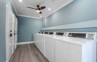 A row of washing machines in a laundry room.
