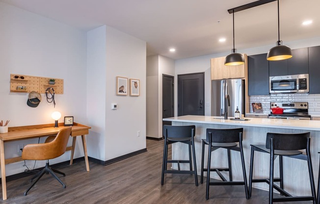 a kitchen and dining area with a bar and stools
