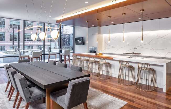 A modern dining room with a long table and chairs.