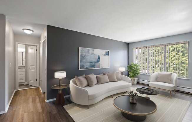 a living room with a white couch and a table at Town & Country Apartments - Wixom, MI, Wixom, Michigan