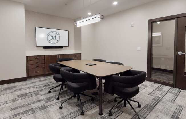 a small conference room with a table and chairs