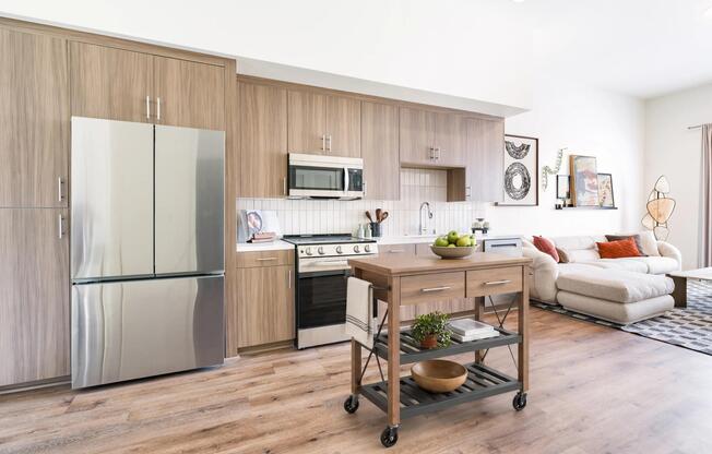 Gourmet kitchens feature stainless steel appliances, contemporary cabinetry, and a movable island that adds flexibility for meal prep, dining, and entertaining.