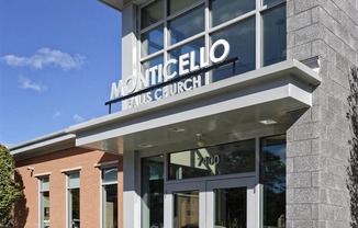 The front of a Monticello French Church with a clear blue sky in the background.