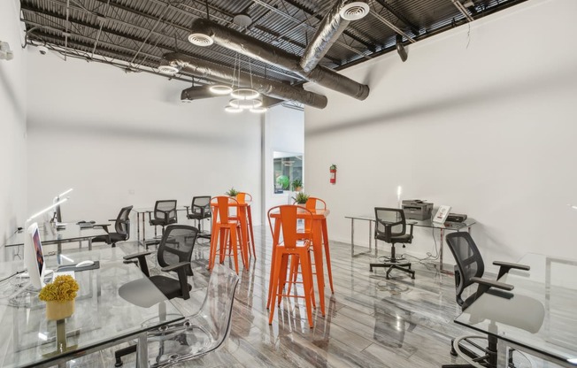 a room filled with chairs and tables and exposed pipes