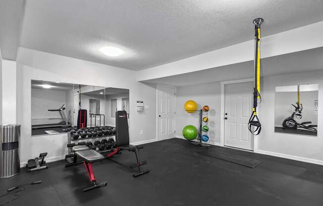 A well-equipped home gym with a variety of exercise equipment.