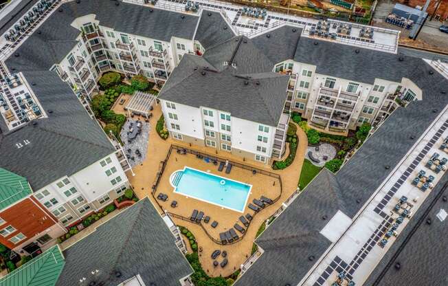 an aerial view of the resort style pool and hot tub at the reserve at south coast apartments at West 130, West Hempstead, 11552