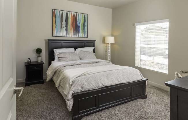 a bedroom with a large bed and two nightstands