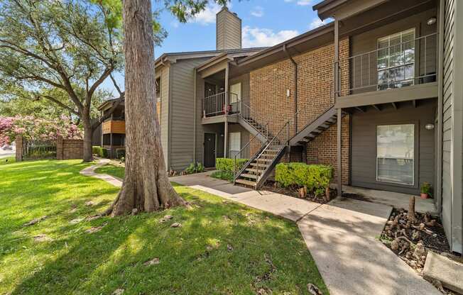 A tree is in front of a house.