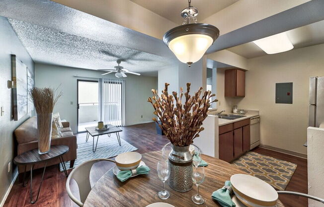 a dining room table with a kitchen in the background