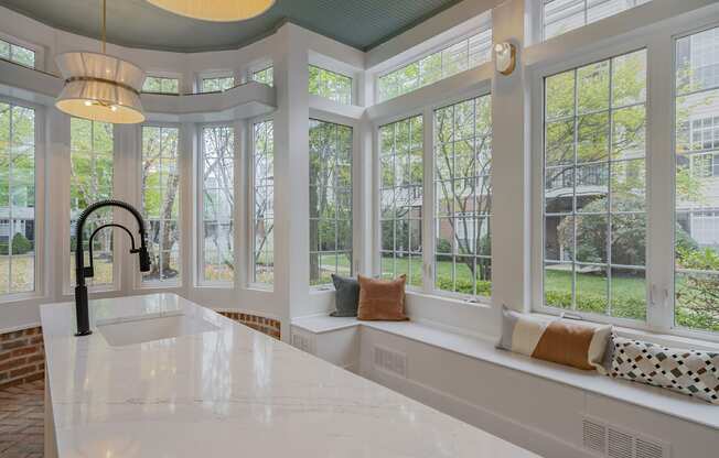 a kitchen with a sink and a row of windows