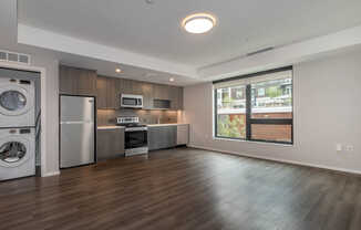 Kitchen with Stainless Steel Appliances and In-home Washer and Dryer