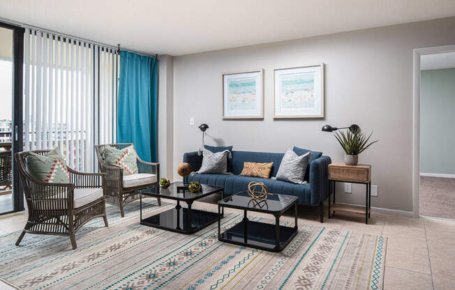 a living room with a blue couch and two chairs at Fairways of Inverrary, Lauderhill, Florida