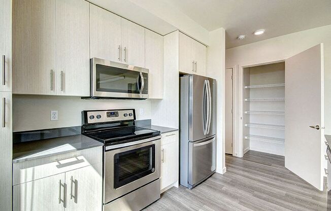 A kitchen with a stove, oven, and refrigerator. at Ravello Apartments, Redmond, WA, 98052