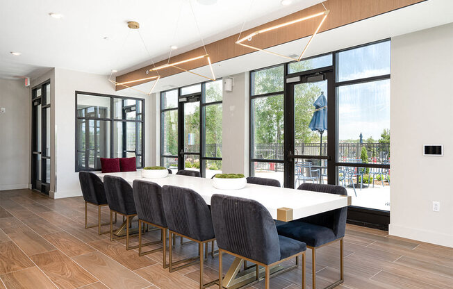 a dining room with a table and chairs and windows