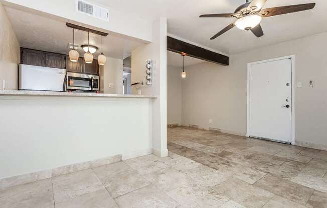 A kitchen area with a refrigerator, microwave, and oven.