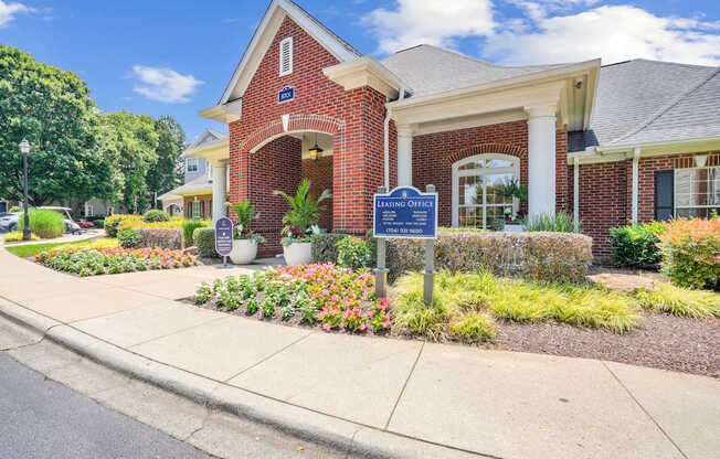 A brick building with a sign that says Leasing Office.