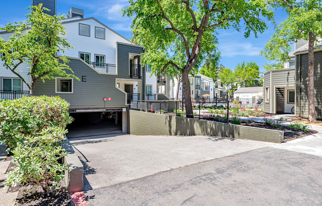 A modern house with a grey exterior and a driveway leading to the garage.