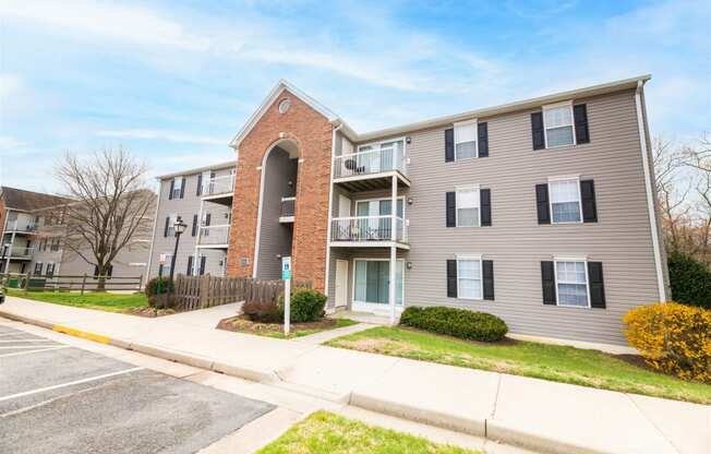 a picture of an apartment building with a sidewalk in front of it