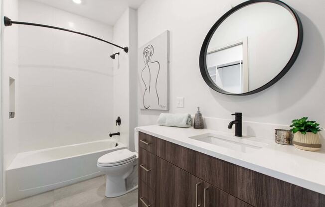 a bathroom with a sink and a toilet and a shower