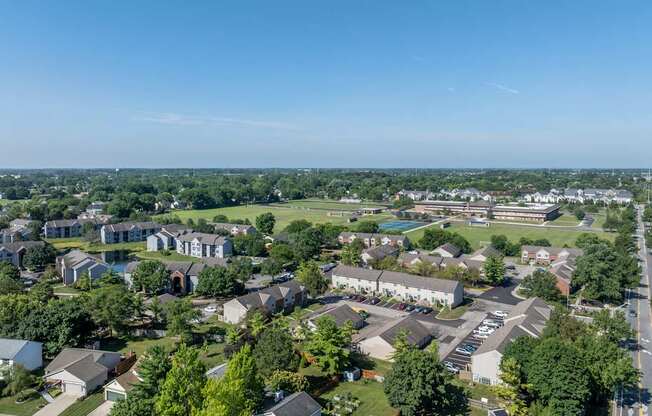 A bird's eye view of a residential area with houses and trees.