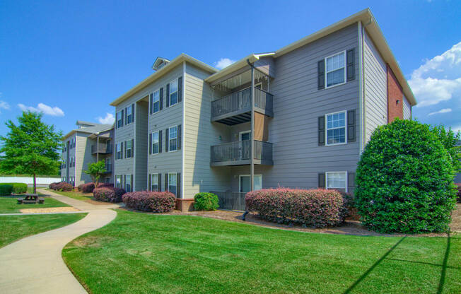 eLancaster Place Apartments in Calera Alabama photo of community building with beautiful landscaping