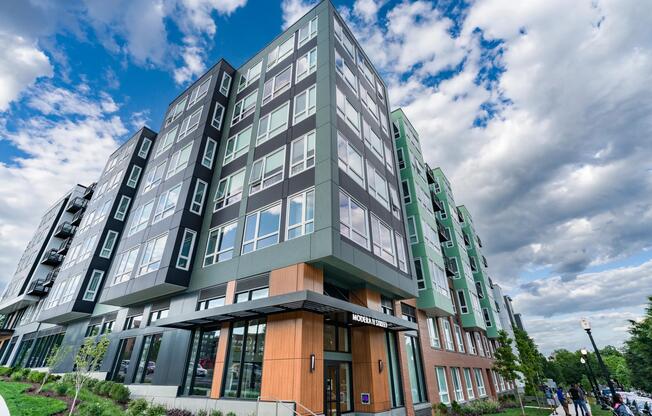 Corner view of the H Street community with layered façades, expansive windows, and street-facing design that connects seamlessly to the surrounding neighborhood.