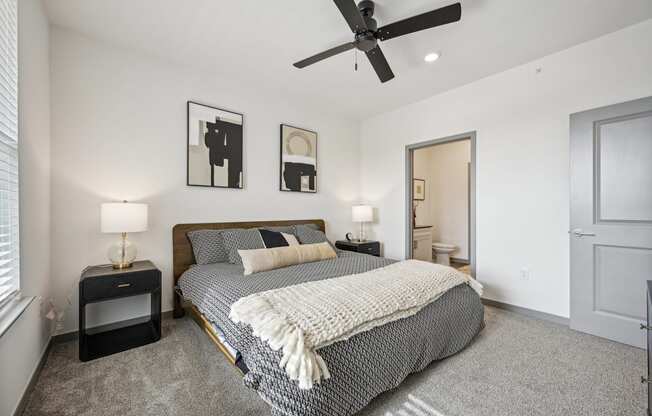 a bedroom with a bed and a ceiling fan at The Quarry Luxury Apartment Homes, Colorado, 80526