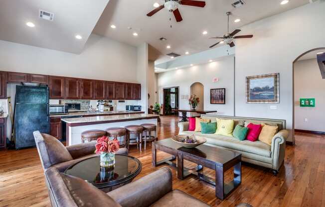 a living room with a kitchen and a couch and a table