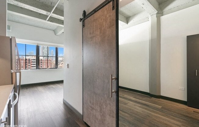 a sliding barn door in an empty room with a window