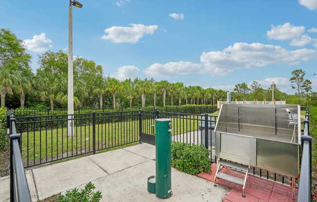 a fenced in area with a hot pool and a fence
