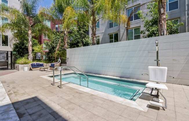 a swimming pool in the middle of a building with palm trees