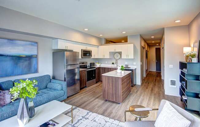 Bothell, WA Apartments for Rent - Open-Concept Kitchen with Wood Flooring, Stainless Steel Appliances, and Mobile Island