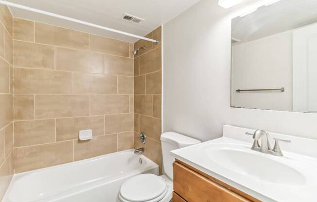 a bathroom with a sink toilet and bath tub