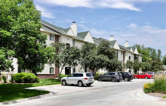 A white car is parked in front of a building.