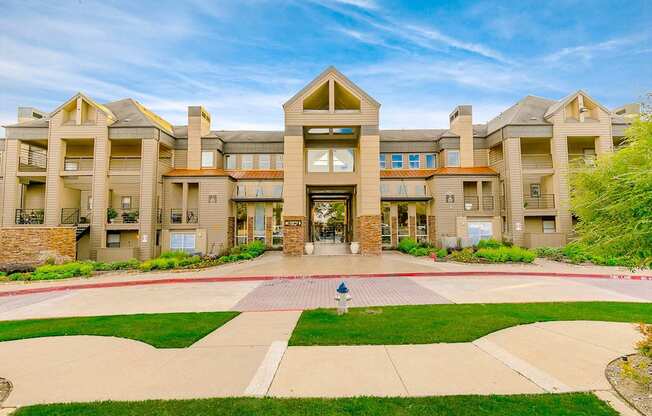 a large building with a lawn in front of it