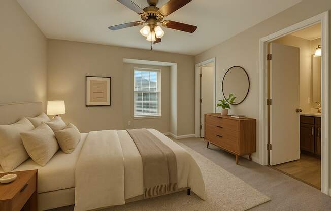 A bedroom with a large bed and a ceiling fan.