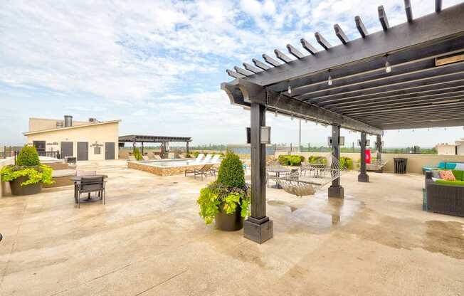 the patio has a pool and lounge area with chairs and tables