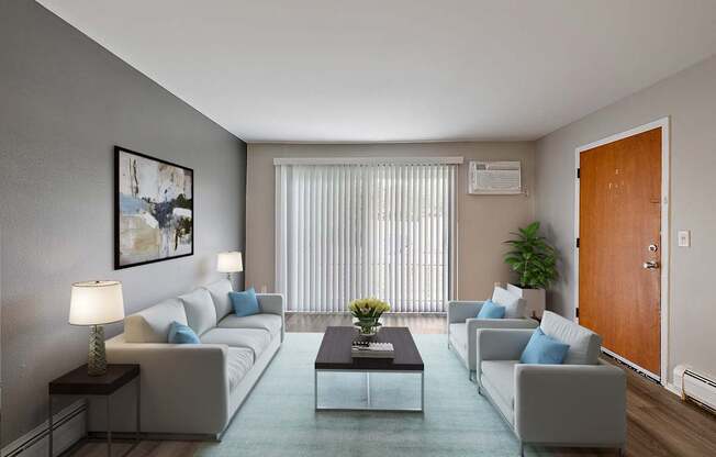 A living room with a grey couch, a coffee table, and a painting on the wall.