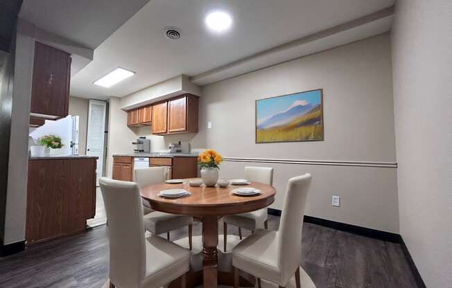 a dining room with a table and chairs and a kitchen