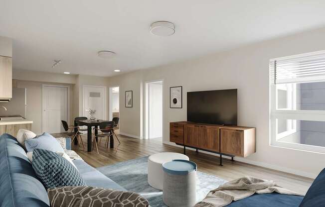 A modern living room with a blue sofa and a television.