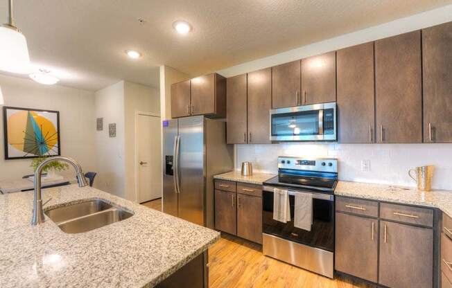 a kitchen with a sink stove and refrigerator  at Fusion, Florida