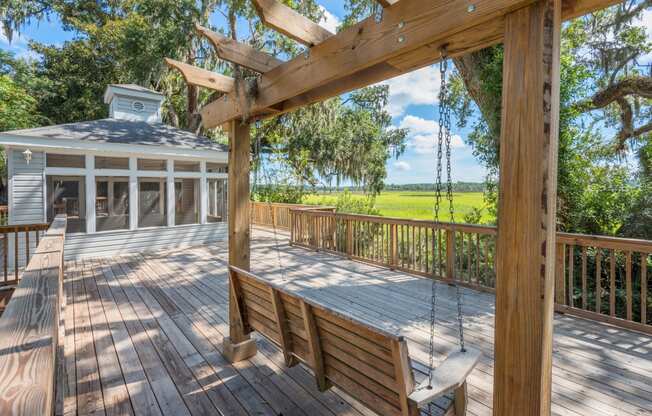 a large deck with a swing and a gazebo