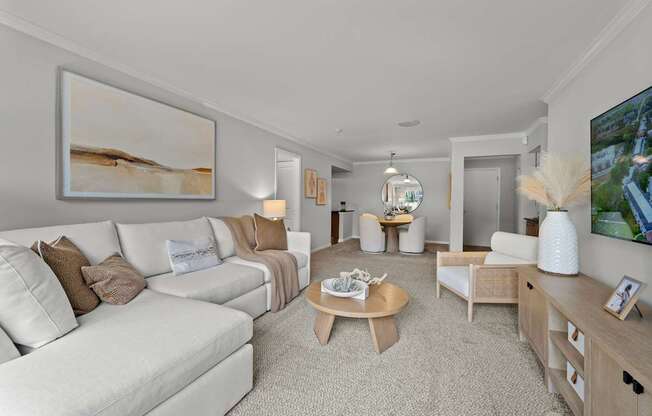 A living room with a white couch and a coffee table.