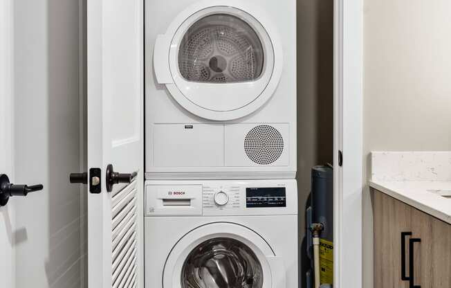 a white washer and dryer in a small laundry room
