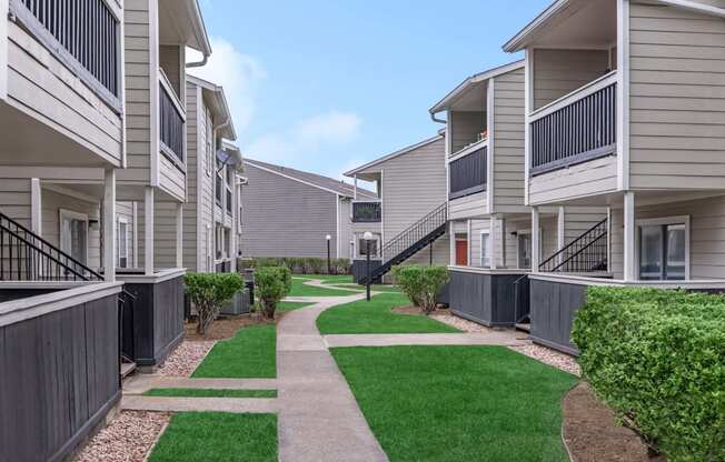 Walk path at Royal Wildewood Manor Apartments, Clute, TX, 77531