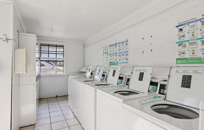 A row of washing machines in a laundromat.
