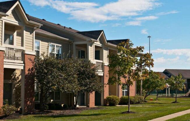 Apartment building exterior with trees and landscaping