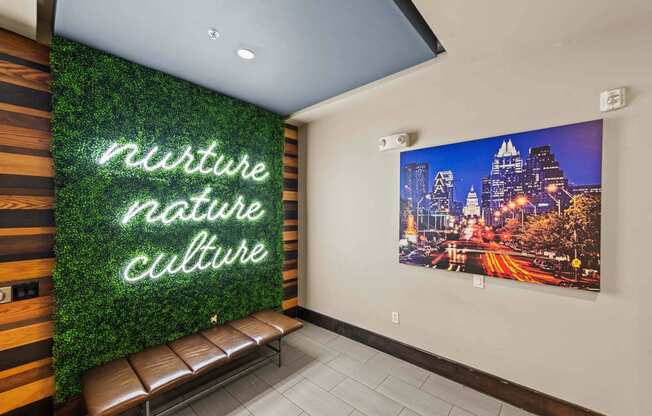 a green wall with a mural and benches in a lobby